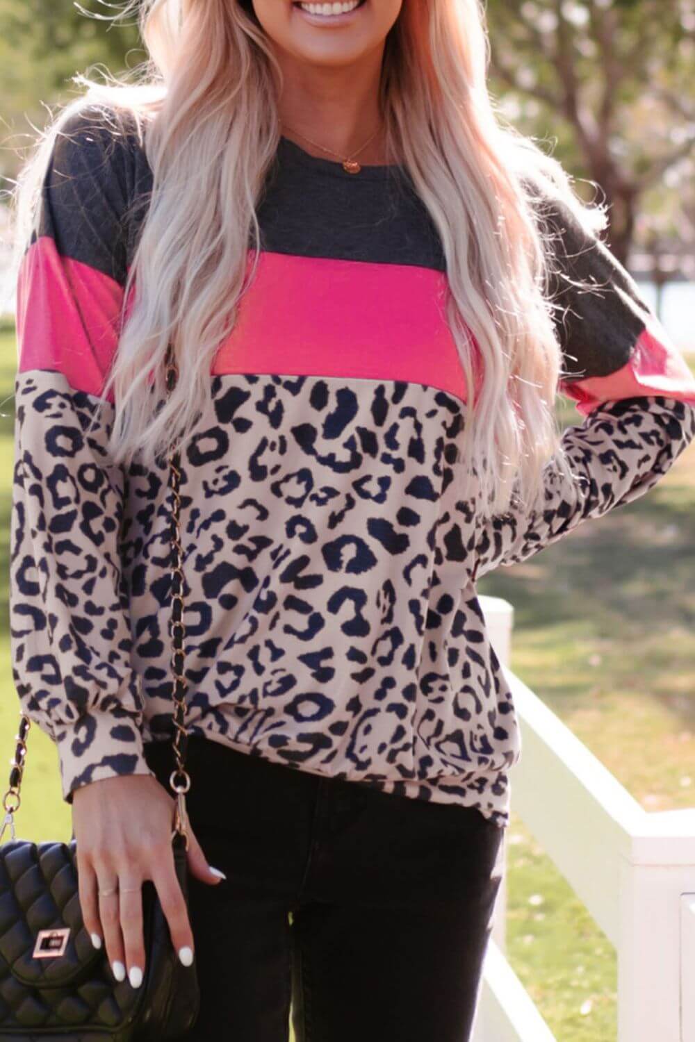 Woman wearing Leopard Print Color Block Long-Sleeve Top featuring pink and black hues, perfect for embracing the wild side.