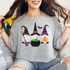 Woman wearing grey Halloween Gnome Graphic Tee with "Take Me to the Pumpkin Patch" multicolor DTF print featuring witches and pumpkins.