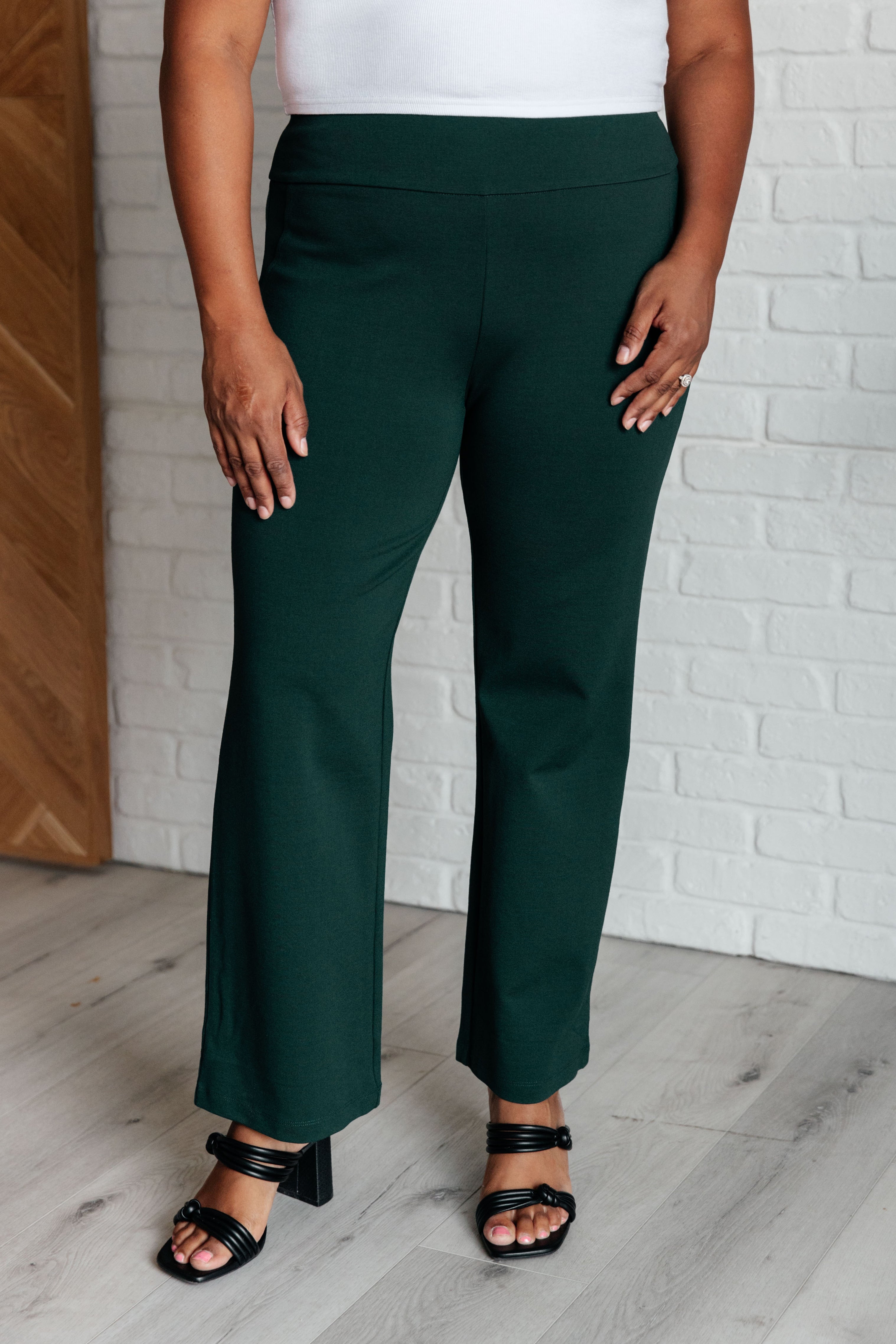 Woman wearing Magic Straight Pants in Hunter Green with elastic waistband and straight leg silhouette.