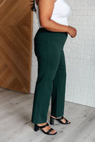 Woman wearing Magic Straight Pants in Hunter Green with elastic waistband and straight leg silhouette