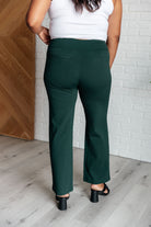 Back view of person wearing Magic Straight Pants in Hunter Green with faux welt pockets, straight leg, and elastic waistband.