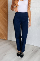 Woman wearing Magic Straight Pants in Navy with elastic waistband, faux welt pockets, and straight leg silhouette