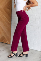 Woman wearing Magic Straight Pants in Wine with elastic waistband and straight leg silhouette, showing side view.