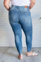 Back view of Nicole Tummy Control Skinny Jeans in vintage wash stretch denim by Judy Blue, showing high waist and decorative stitching.